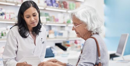 elderly woman talks to her pharmacist