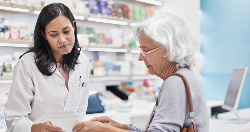 elderly woman talks to her pharmacist